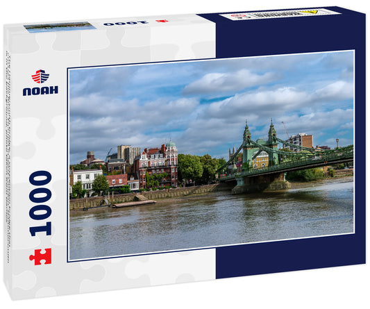 The Hammersmith Bridge, a suspension bridge that crosses the River Thames in west London. Hammersmith is in the background, photo taken from Barnes