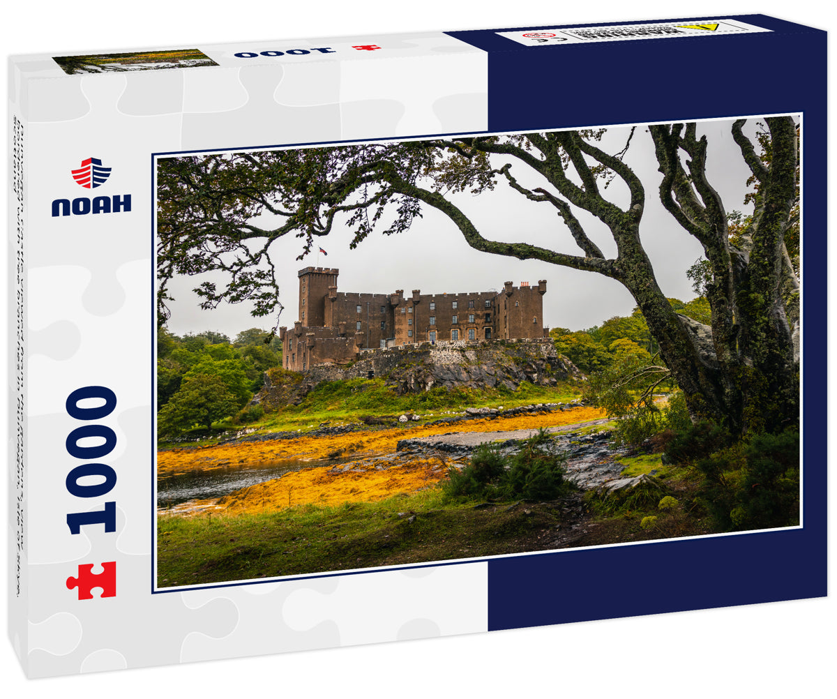 Dunvegan Castle viewed from the gardens, view bordered with tree branches in Dunvegan, Isle of Skye, Scotland