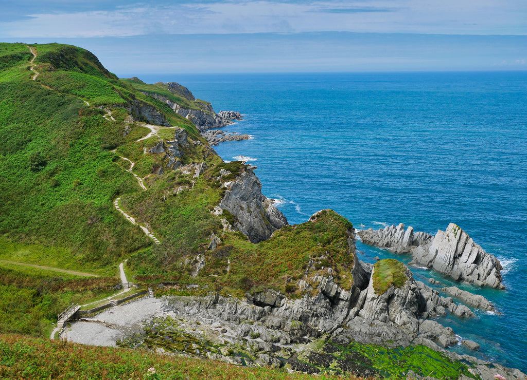 The north Devon coast near Lee Bay showing the steeply inclined slate strata of the Morte Slates Formation - sedimentary bedrock formed in the Devonian Period