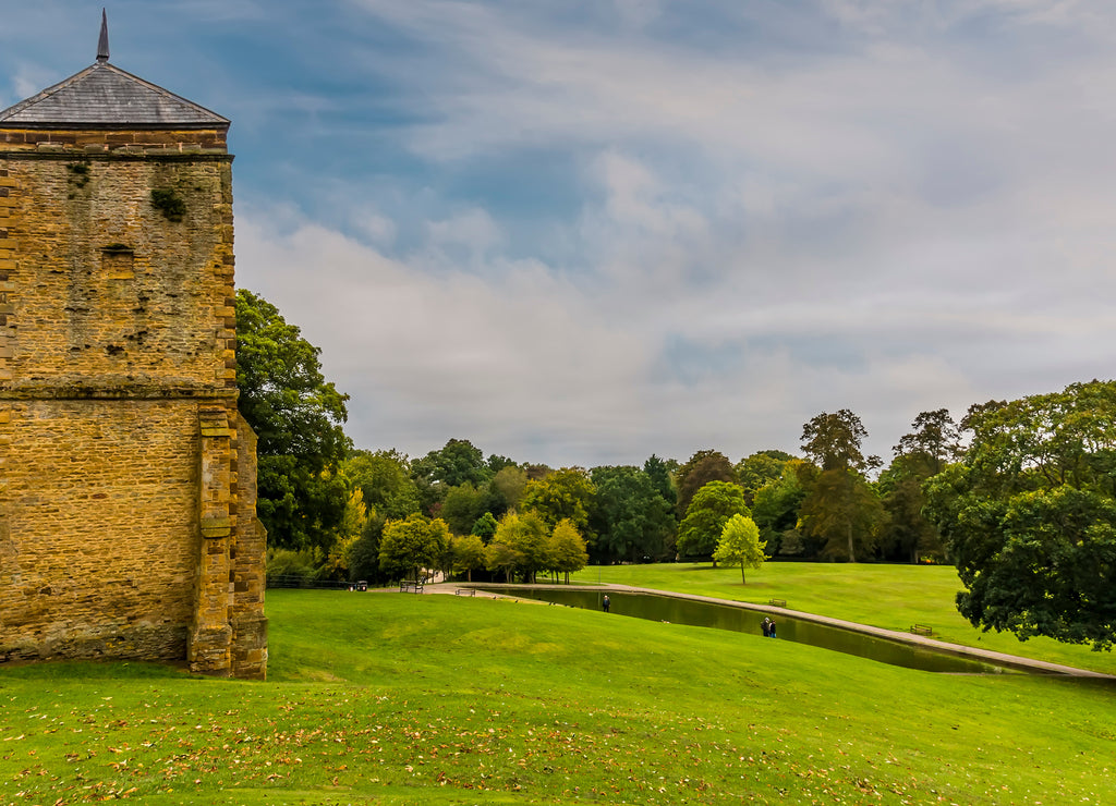 A view past a medieval ruin in Abington Park, Northampton, UK in the summertime