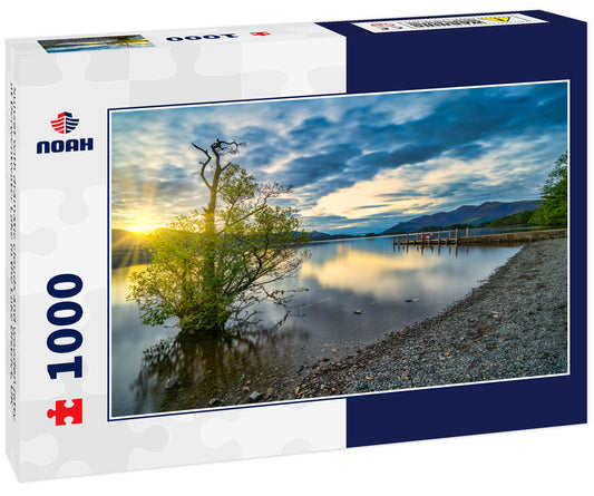 Sunset with dramatic clouds and wooden jetty at Derwentwater Lake in the Lake District, UK