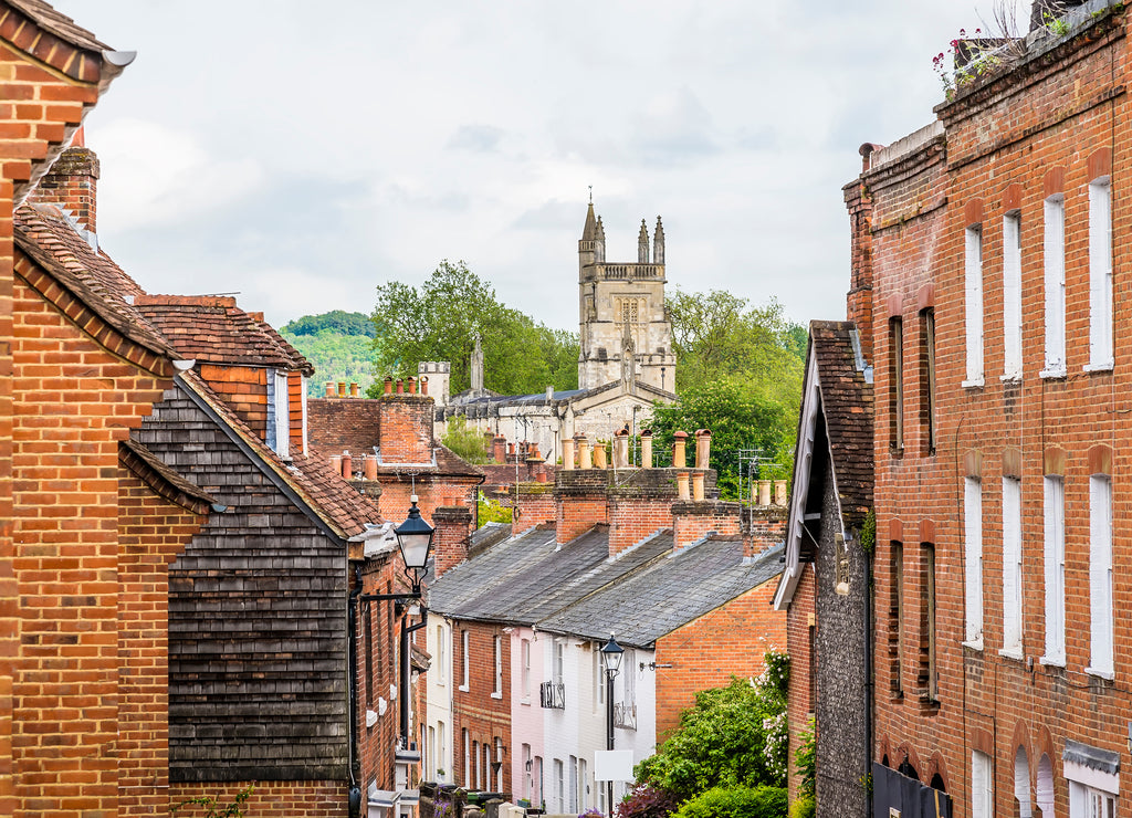A view down narrow street towards the Cathedral in Winchester, UK in early summer