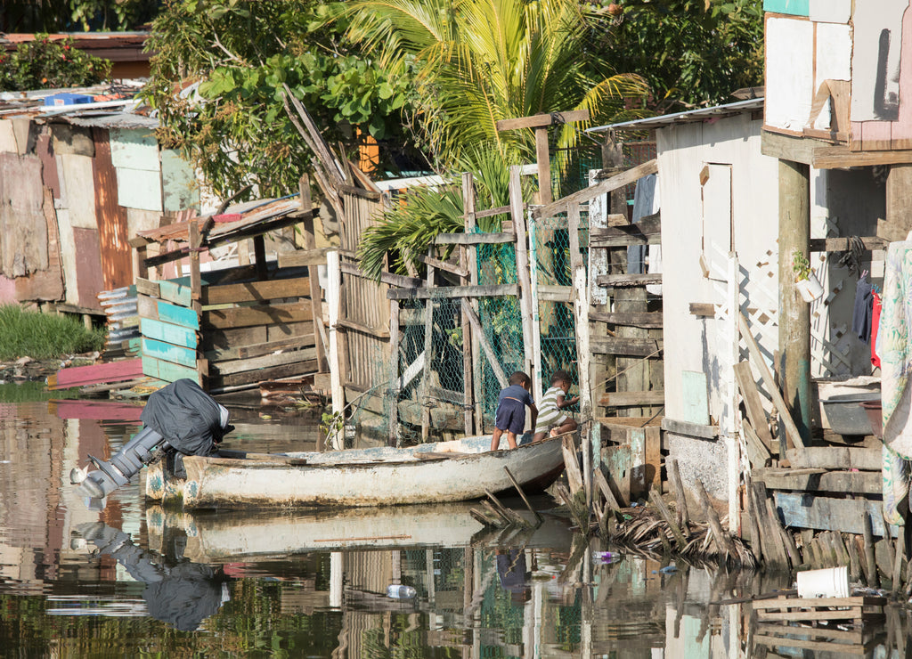Kids play in a boat in a waterfront slum in Honduras
