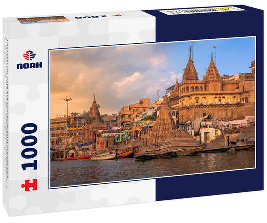 Varanasi city with old architectural buildings and temples along the Ganges river ghat as viewed from a boat at sunset