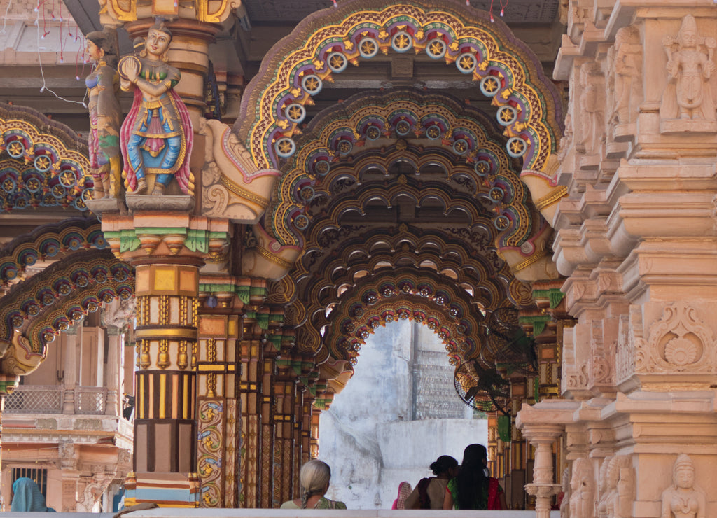 The brightly decorated Burmese teak archways in the a Hindu temple in Ahmedabad, India