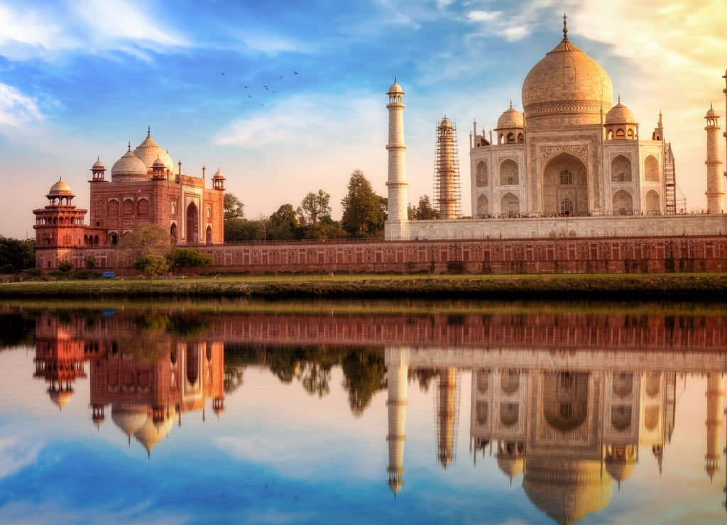 Taj Mahal Agra with view of the East gate at sunset with water reflections
