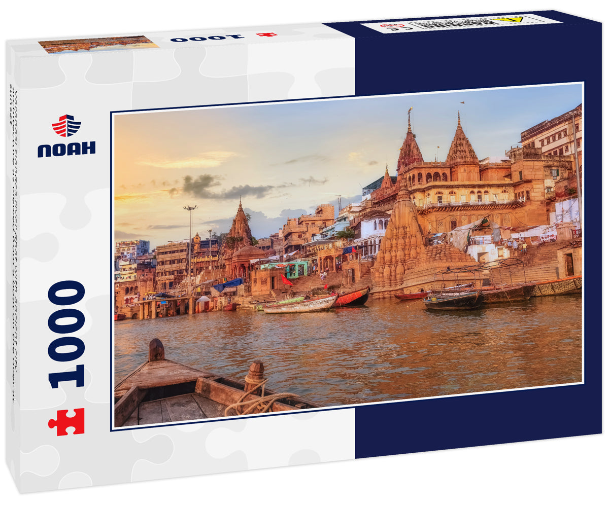 Varanasi Ganges river ghat with ancient city architecture as viewed from a boat on the river at sunset