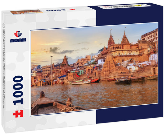 Varanasi Ganges river ghat with ancient city architecture as viewed from a boat on the river at sunset