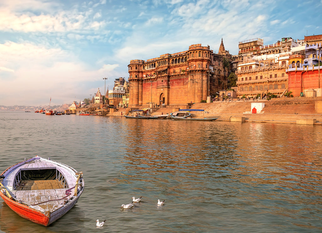 Ancient Varanasi India city architecture with view of Ganges river ghat at sunset