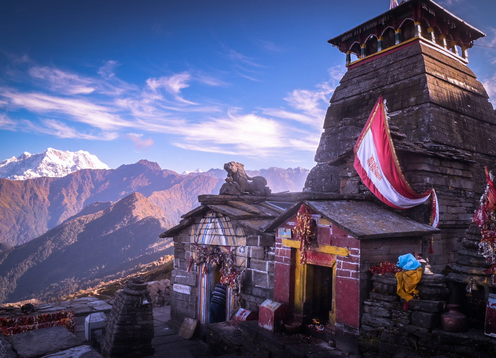 Beautiful panoramic landscape view of the Lord Shiva temple at the highest altitude of Himalaya. Snow-capped mountains from Chandrashila peak in Chopta, Uttarakhand, India