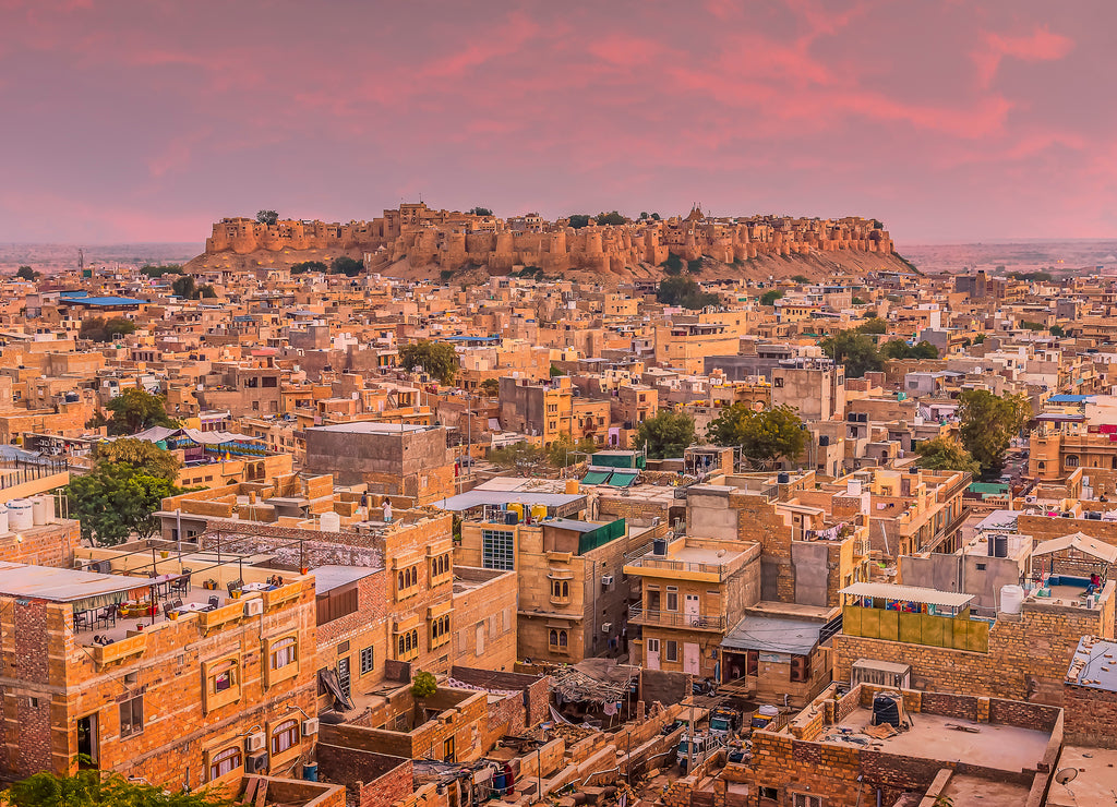 The golden city of Jaisalmer glows beneath the setting sun in Rajasthan, India