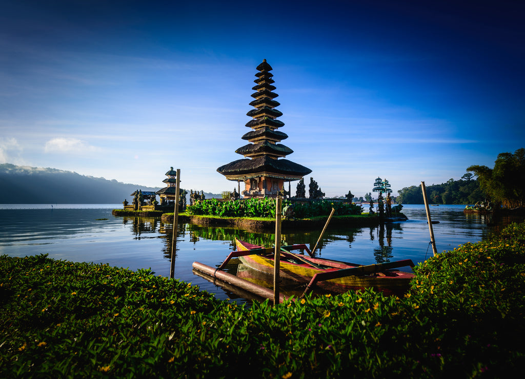 Pura Ulun Danu Bratan, Hindu temple with boat on Bratan lake landscape at sunrise in Bali, Indonesia
