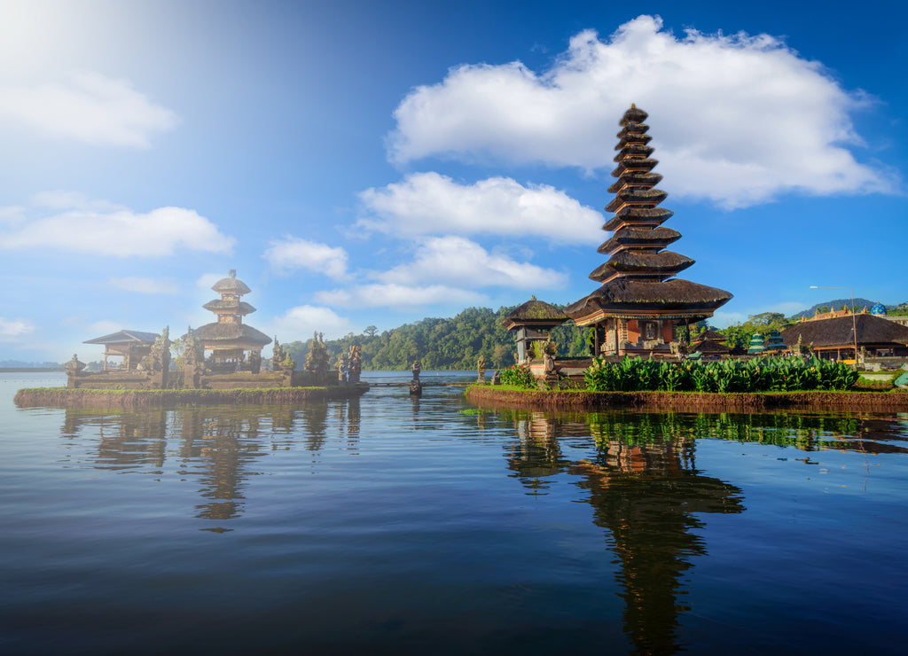 Pura Ulun Danu Bratan, Hindu temple with boat in Bratan lake landscape on blue sky background at Bali, Indonesia