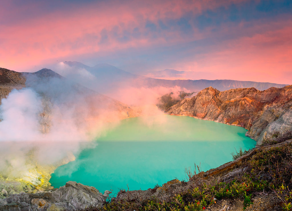 Panorama landscape view of Kawah Ijen at sunrise sky. The most famous tourist attraction in Indonesia