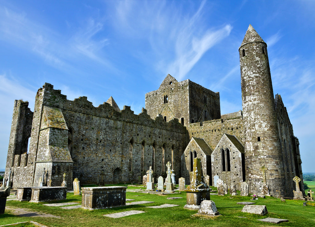 Famous ancient ruins of the Rock of Cashel. Close up view with tower from the old burial grounds
