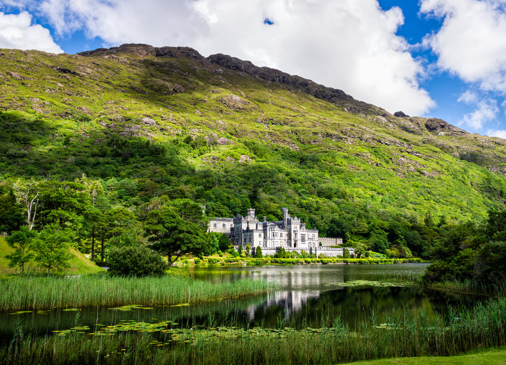 Kylemore Abbey with reflection in lake at the foot of a mountain. Connemara, Ireland