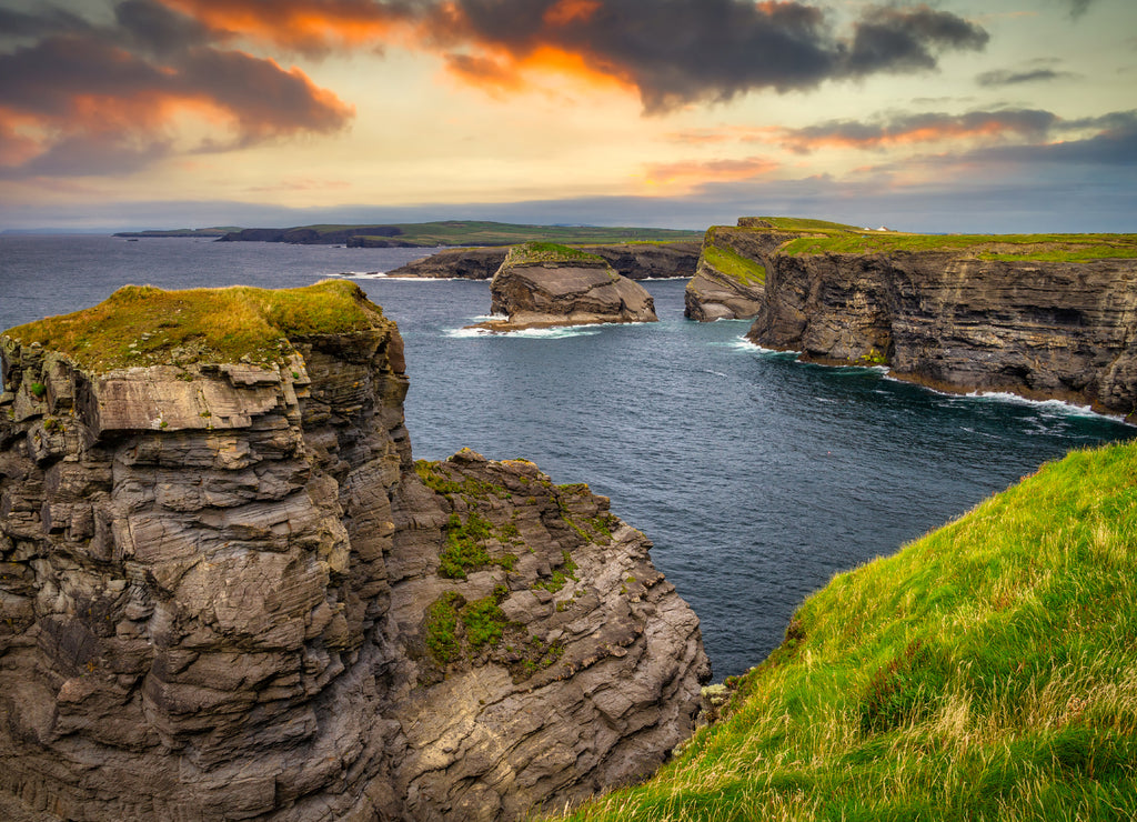 Rocky cliffs in Kilkee at sunset, County Clare. Ireland