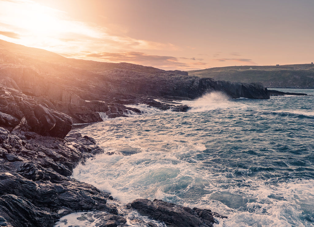 Sunrise over rough stone coast line. South of Ireland