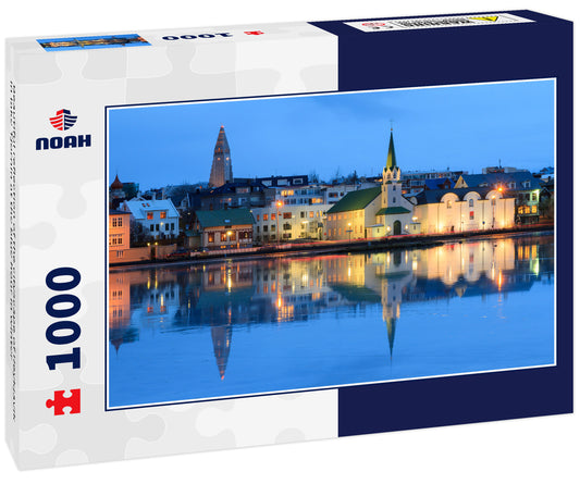 Beautiful reflection of the cityscape of Reykjavik in lake Tjornin at the blue hour in winter