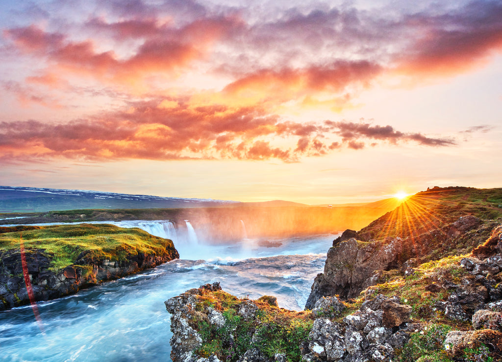 The picturesque sunset over landscapes and waterfalls. Kirkjufell mountain