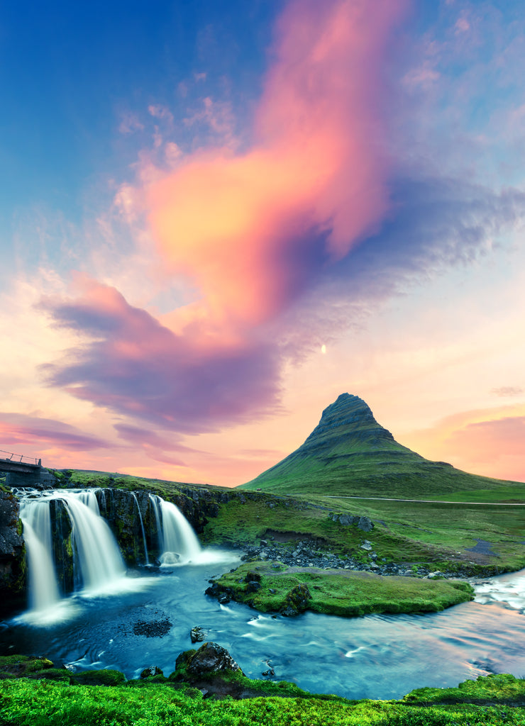 Colorful sunrise on Kirkjufellsfoss waterfall. Amazing morning scene near Kirkjufell volkano, Iceland