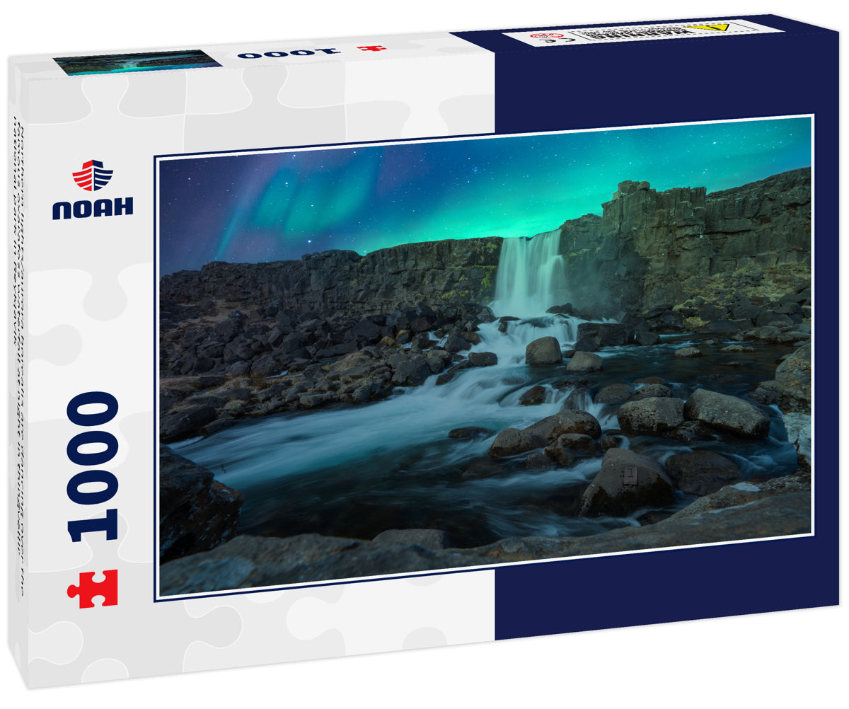 Northern lights/aurora borealis are dancing over the famous oxarafoss waterfall at night in thingvellir national park in Reykjavik