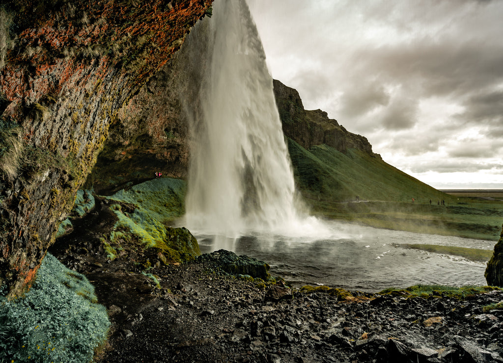 At the base of the Seljalandsfoss waterfall in Iceland