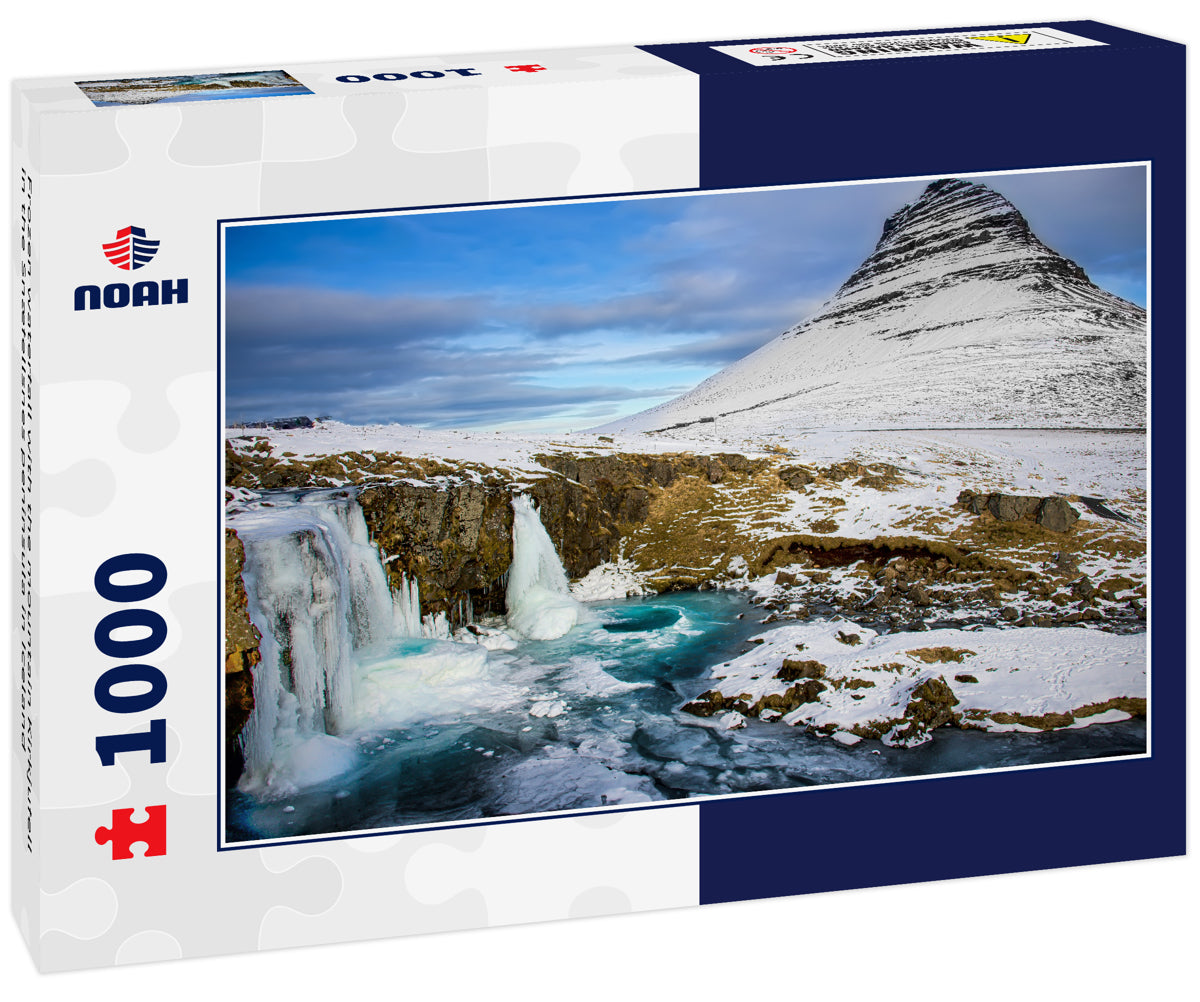 Frozen waterfall with the mountain Kirkjufell in the Snæfellsnes peninsula in Iceland