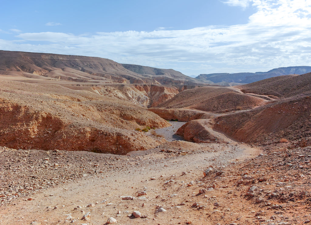 Dirt road in desert Negev, Israel, transport infrastructure in desert, scenic mountains route from Eilat to north of Israel