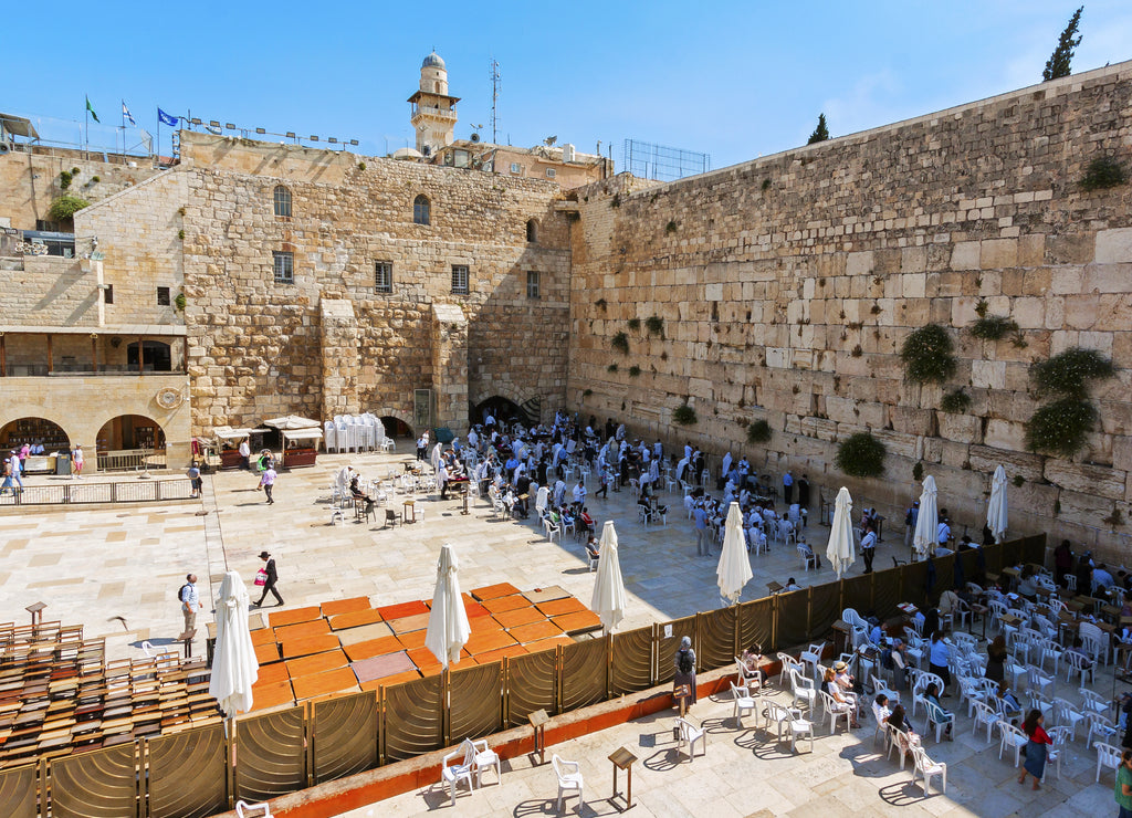 Praying people at the Wailing Wall. Visible division into two separate parts - for men and for women. Temple Mount, Jerusalem, Israel