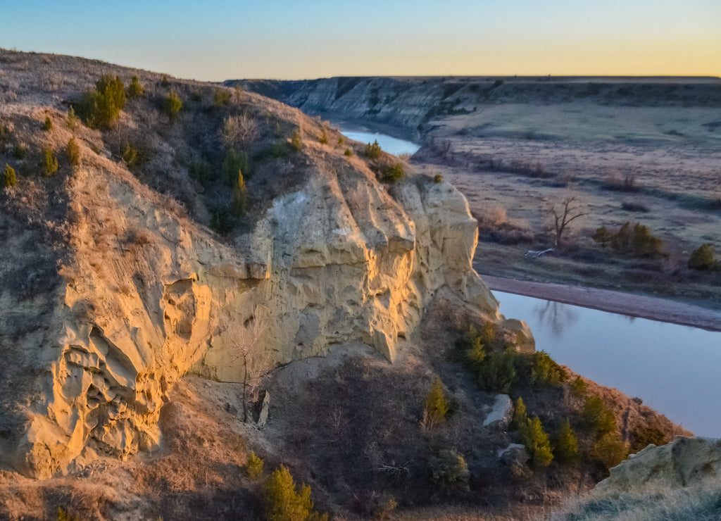 View of the winding river from the mountain in the evening at sunset. North Dakota