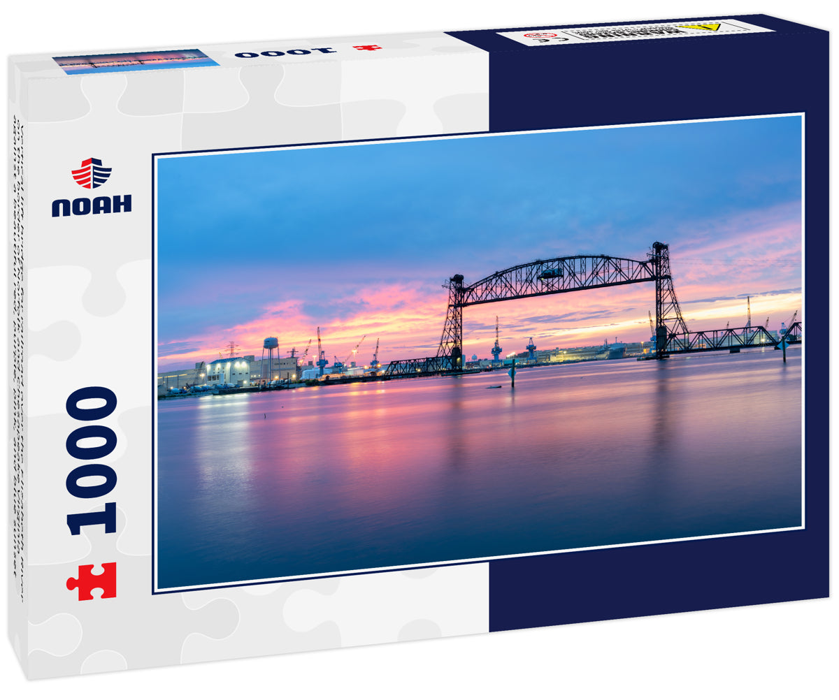 Vertical lift bridge for railroad over the Elizabeth River on the border of Norfolk and Chesapeake Virginia against a beautiful red, purple, pink, and blue sunset