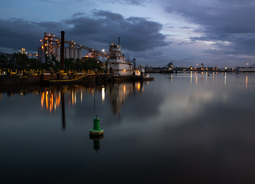 Tug boats on the Elizabeth River in Virginia after sunset, reflections in the water