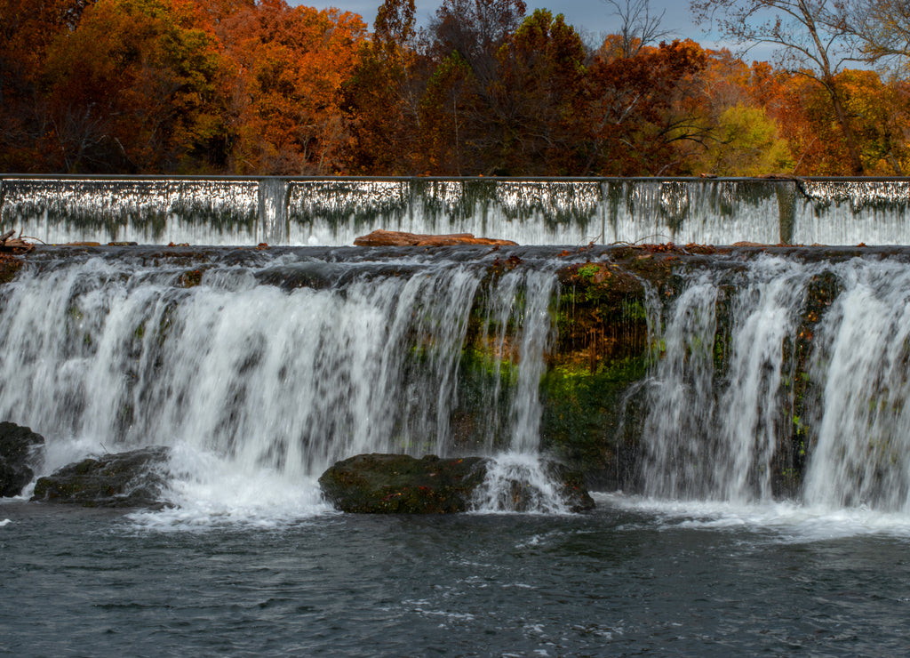 Vivid fall colors surround this fabulous waterfall scene in the Ozarks in Joplin, Missouri