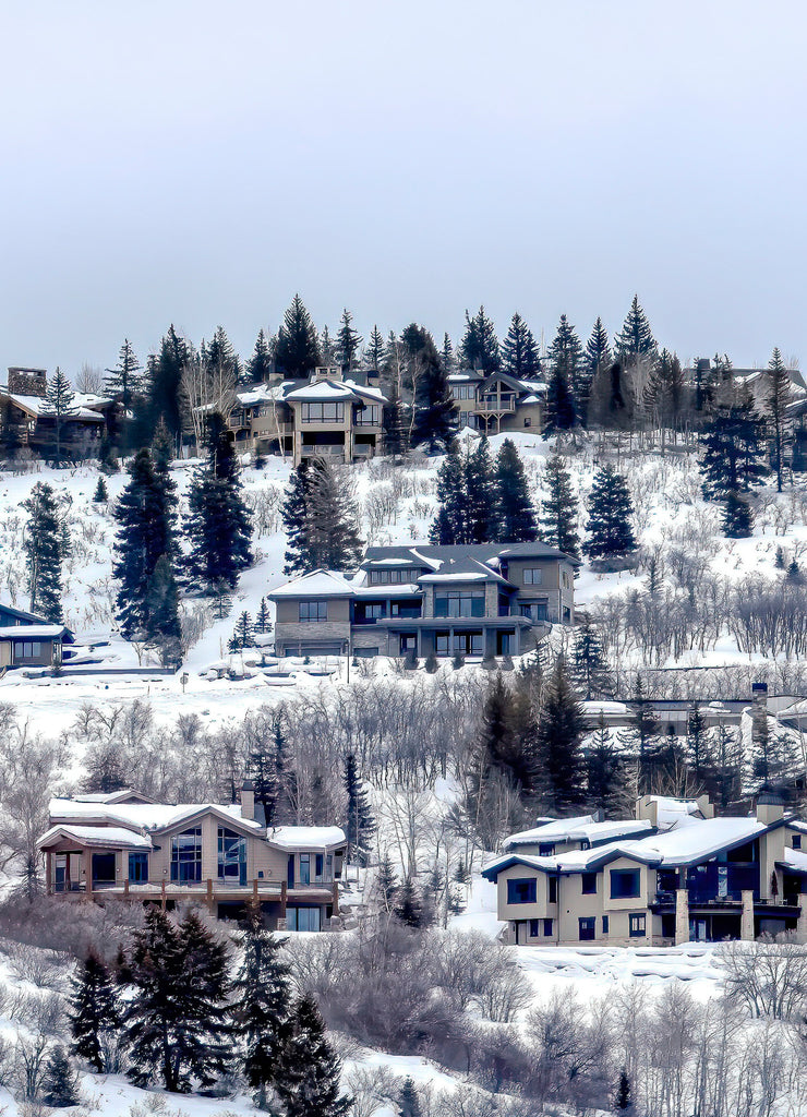 Square crop Park City Utah neighborhood in winter with colorful homes on snowy hill top
