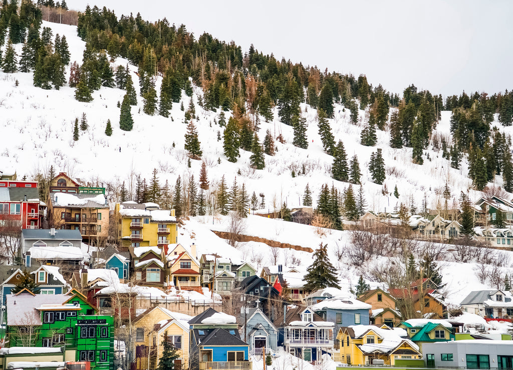 Houses and cabins on a mountain blanketed with snow in Park City Utah in winter