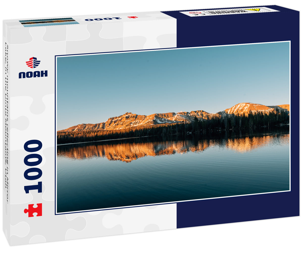 Snowy mountains reflecting in Mirror Lake, in the Uinta Mountains, Utah