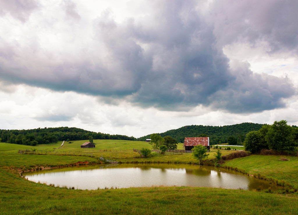 A farm with a pond along a country road in rural Tennessee, USA