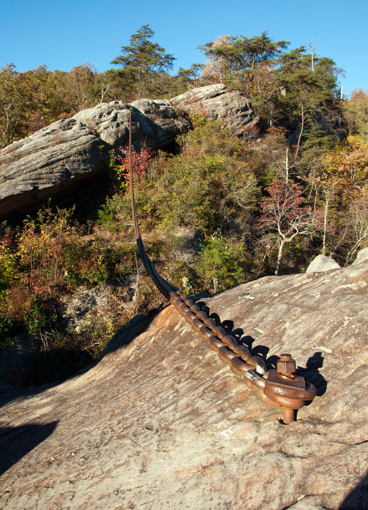 A chain is meant to keep a large boulder from falling on Pineville, Kentucky