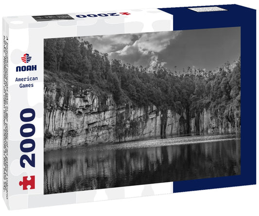 Noah Jigsaw Puzzle A beautiful emerald lake in the crater of an extinct volcano is surrounded by steep cliffs. Coniferous forest on the banks. Reflection on calm water. Clouds in the blue sky. Tritriva lake. Madagascar in black white 2000 pieces