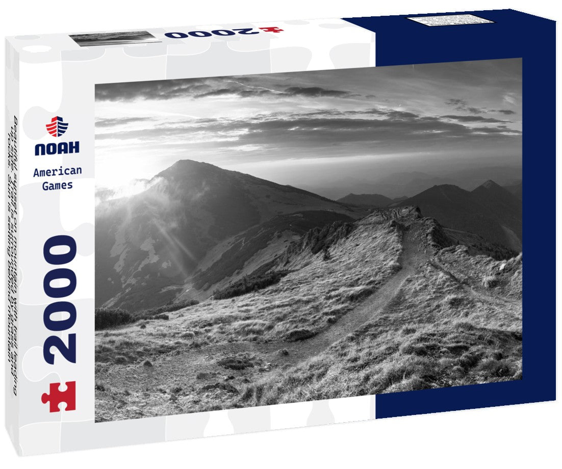 Noah Jigsaw Puzzle Beautiful sunset on mountain with trail leading up side. Trail is surrounded by grass and rocks. Sun is setting behind mountain, casting warm glow on in black white 2000 pieces