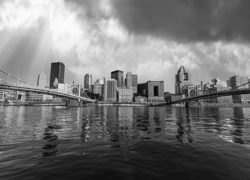 Downtown urban waterfront and bridges with stormy sky in Pittsburgh Pennsylvania in black white