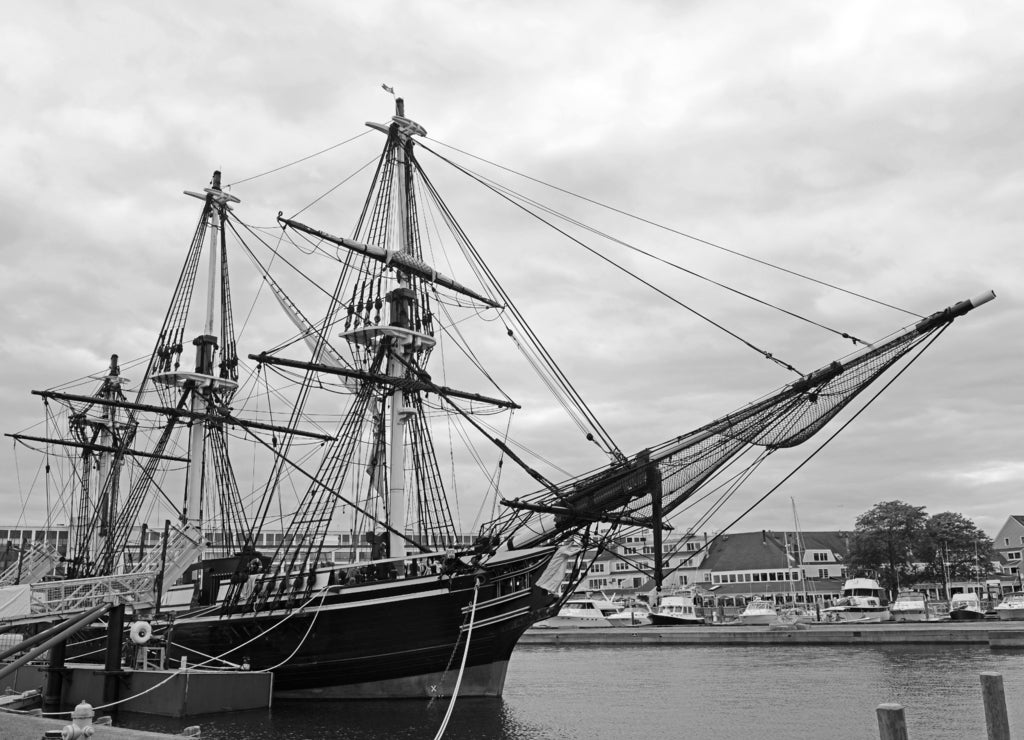 Antique ship Friendship of Salem docked at a pier in the Salem Maritime National Historic Site, Salem Massachusetts in black white