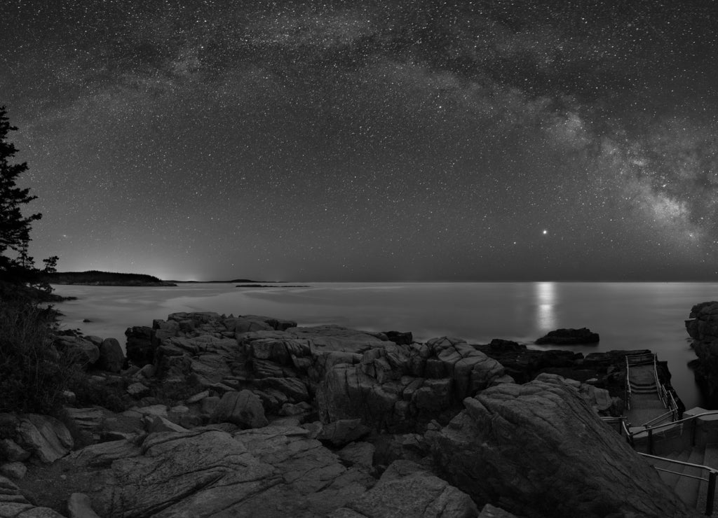 The milky way over thunder hole in Acadia National Park, Maine in black white