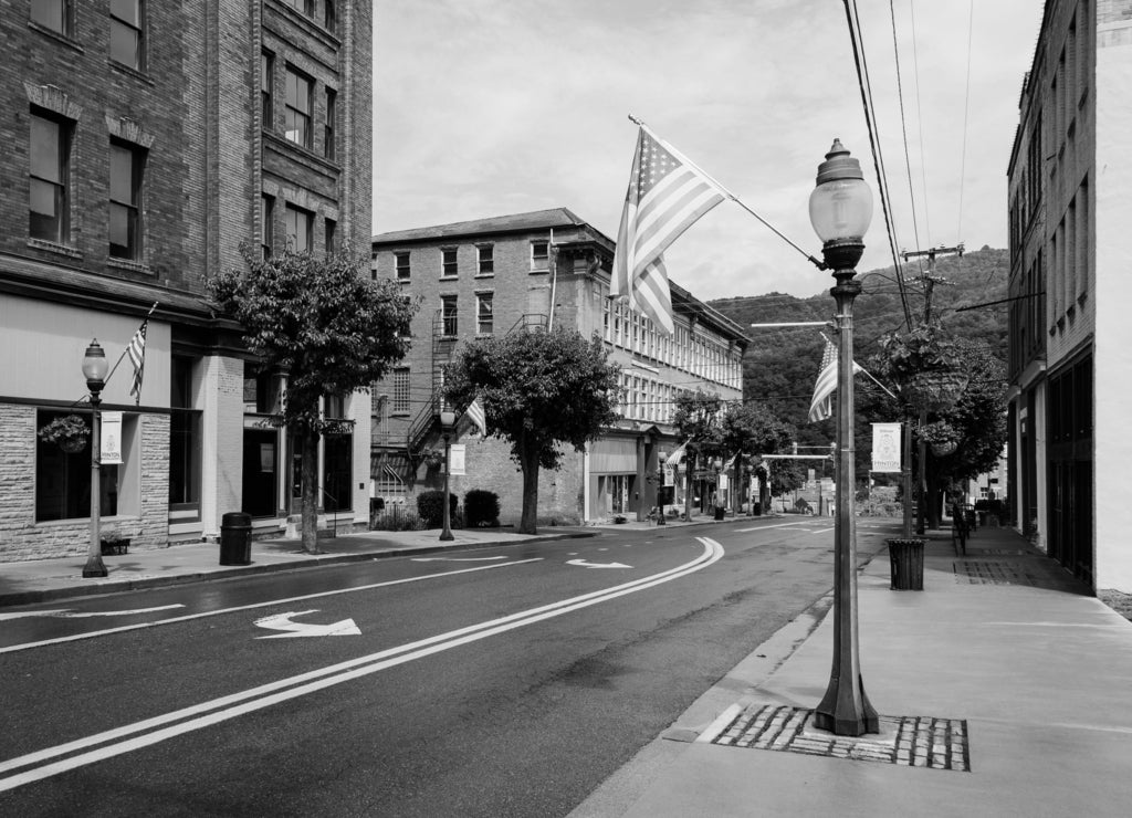 Street and American flags in downtown Hinton, West Virginia in black white