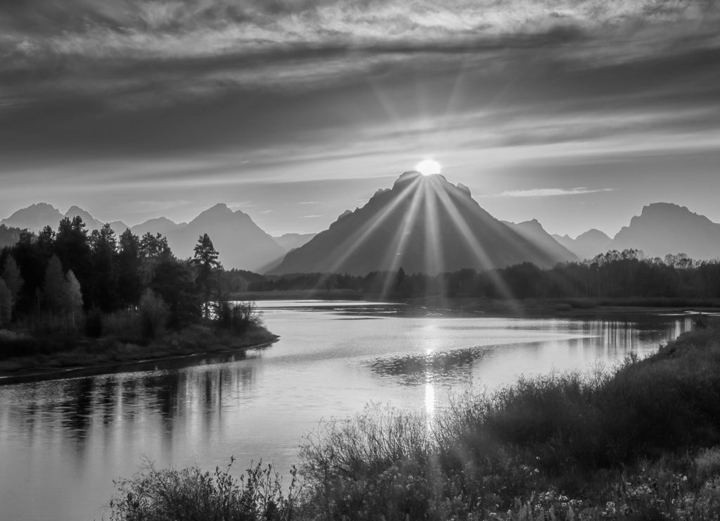 Sun atop of the mountain at Oxbow Bend in Grand Teton National Park, Wyoming in black white