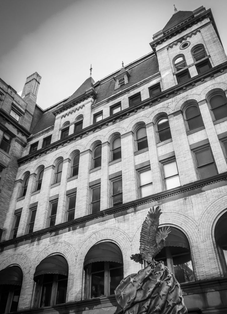 Looking up at a statue and old building in downtown York, Pennsylvania in black white