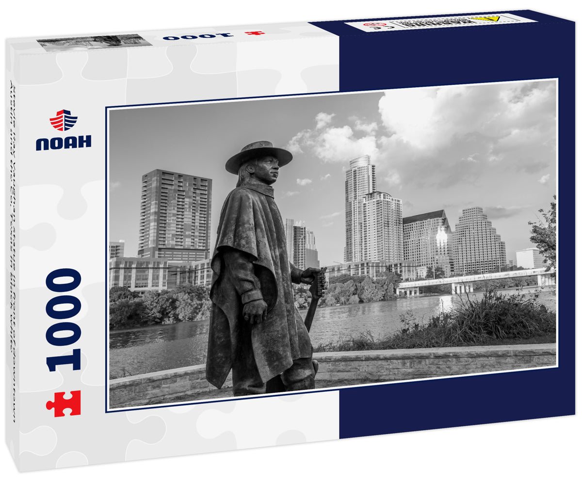 Stevie Ray Vaughan statue in front of downtown Austin and the Co, Texas in black white