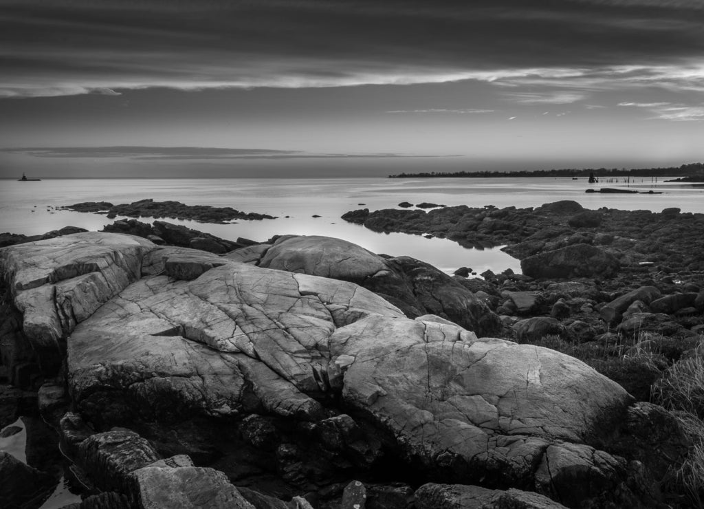 Boulders On The Shore At Sunset With Lighthouse In The Distance, Connecticut in black white