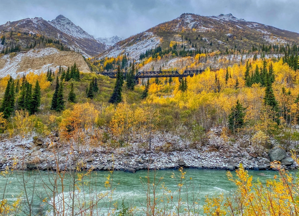 A Beautiful Scene of the River, Lightly Snow-Covered Mountains, Fall Foliage, and Train Bridge in Healy, Alaska